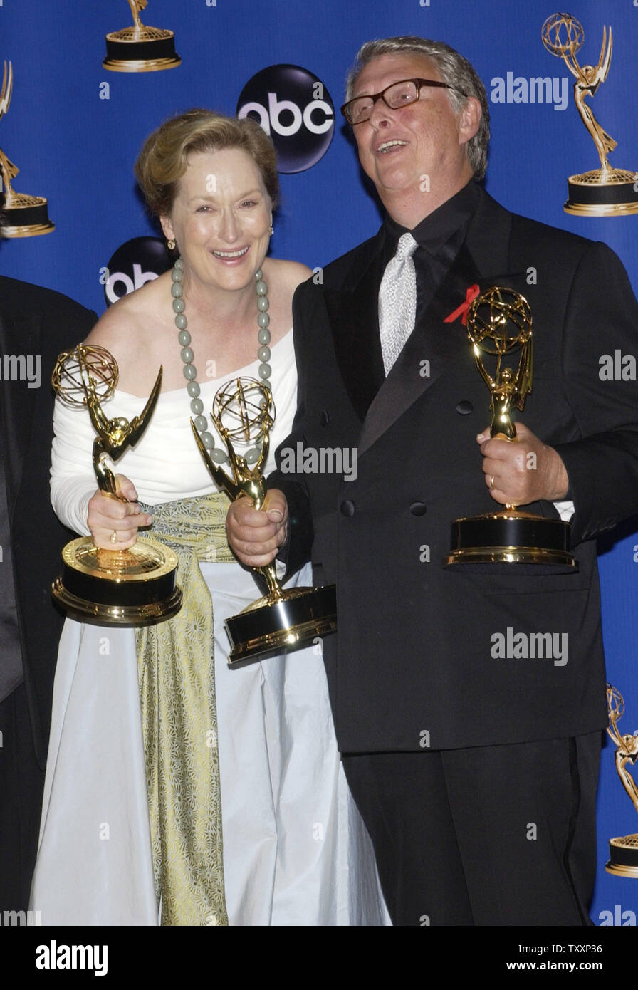 Meryl Streep shares a laugh with director Mike Nichols (R) they pose with her trophies backstage during the 56th Annual Primetime Emmy Awards, Sunday, September 19, 2004 at the Shrine Auditorium in Los Angeles, California. 'Angels in America,' the adaptation of Tony Kushner's Pulitzer Prize-winning play about Americans facing AIDS in the 1980's, was honored as outstanding miniseries and won acting trophies for Al pacino, Meryl Streep, Mary-Louise Parker and Jeffrey Wright. Kusher received a best writing award and Mike Nichols won for best director. (UPI Photo/Jim Ruymen) Stock Photo