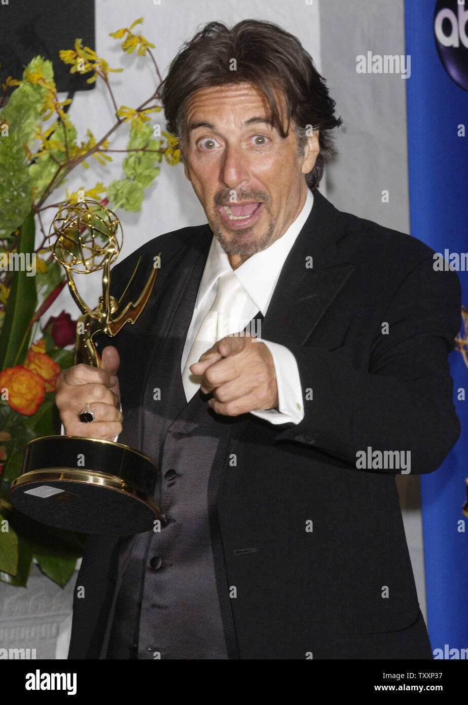 Al Pacino poses with his trophy for lead actor in a miniseries or a movie for his role in 'Angels in America,' during the 56th Annual Primetime Emmy Awards, Sunday, September 19, 2004 at the Shrine Auditorium in Los Angeles, California. 'Angels in America,' the adaptation of Tony Kushner's Pulitzer Prize-winning play about Americans facing AIDS in the 1980's, was honored as outstanding miniseries and won acting trophies for Al Pacino, Meryl Streep, Mary-Louise Parker and Jeffrey Wright. Kusher received a best writing award and Mike Nichols won for best director.   (UPI Photo/Jim Ruymen) Stock Photo