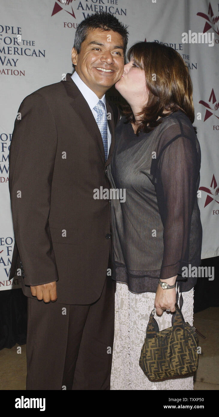 Actor George Lopez receives a kiss from his wife Ann as they arrive for the  People for the American Way Foundation's Spirit of Liberty dinner in  Beverly Hills, California September 21, 2004. (