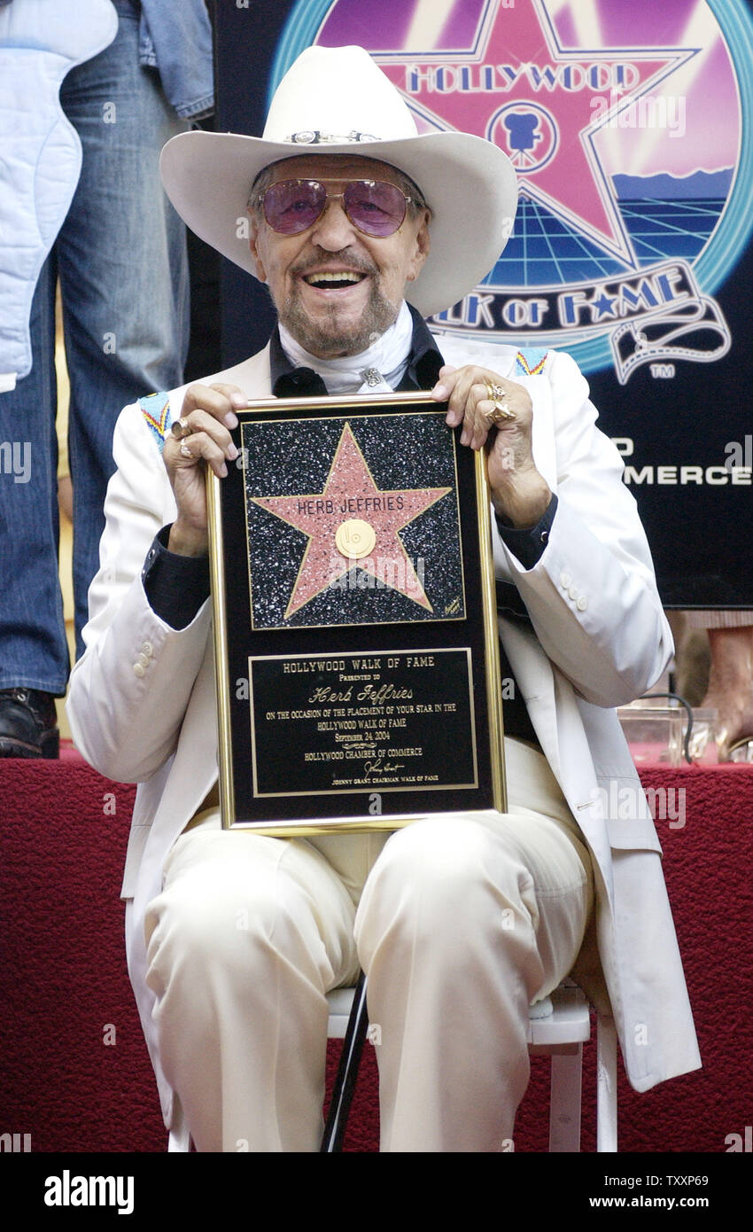 Entertainer Herb Jeffries poses with a replica plaque after he was