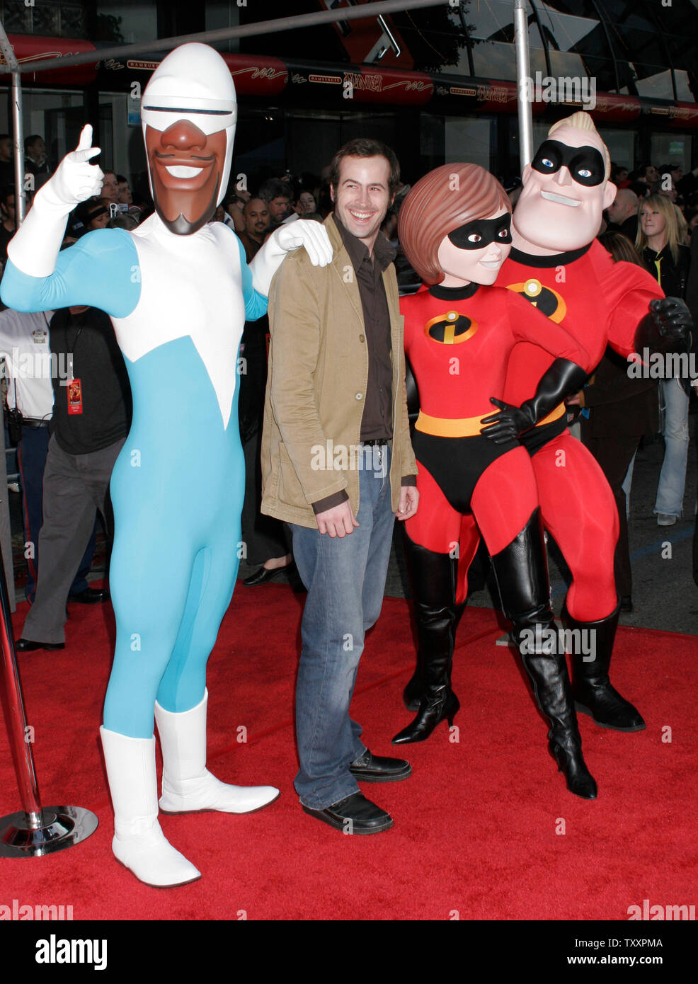 Actor Jason Lee, center, who is the voice of the character, 'Syndrome', poses for photographers with costumed actors at the premiere of the new animated film from Pixar, 'The Incredibles' at the El Capitan Theatre in Los Angeles,  October 24, 2004. The film opens in the United States November 5th. (UPI Photo/Francis Specker) Stock Photo
