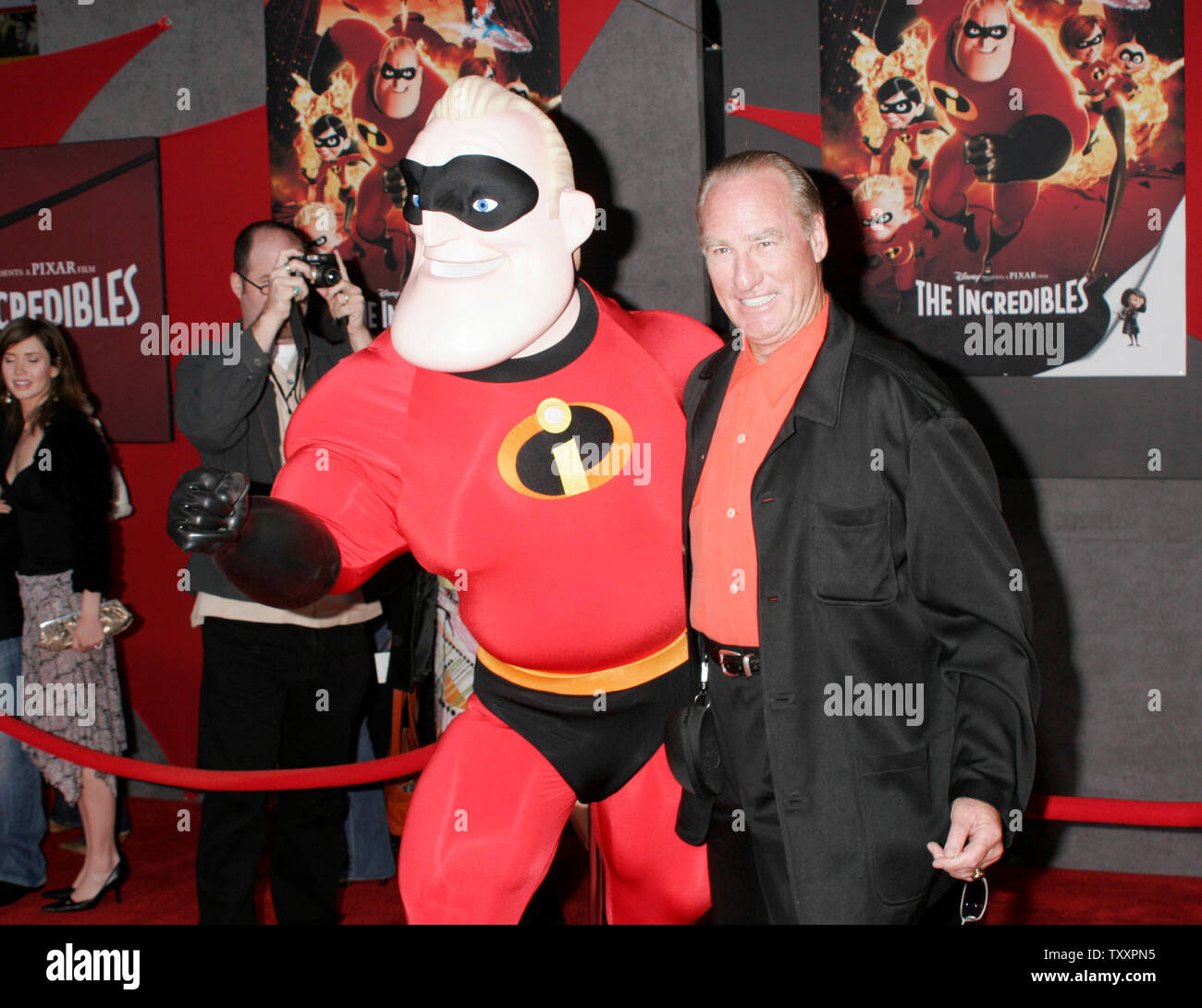 Actor Craig T. Nelson, right, who is the voice of the character, 'Mr. Incredilbe', poses for photographers with a costumed actor dressed as 'Mr. Incredible'  at the premiere of the new animated film from Pixar, 'The Incredibles' at the El Capitan Theatre in Los Angeles,  October 24, 2004. The film opens in the United States November 5th. (UPI Photo/Francis Specker) Stock Photo