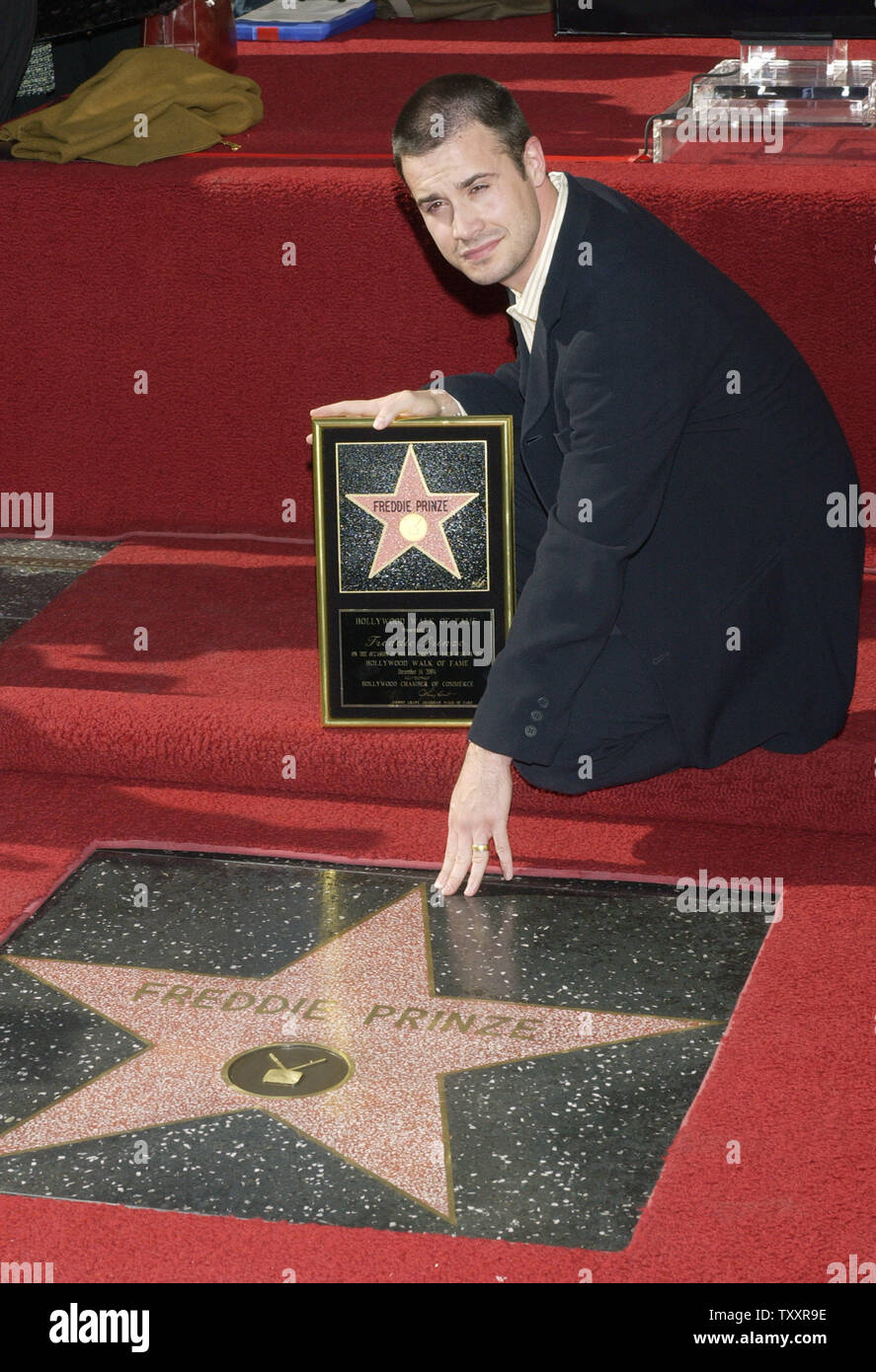 Actor Freddie Prinze, Jr. reaches out to touch the newly unveiled star ...