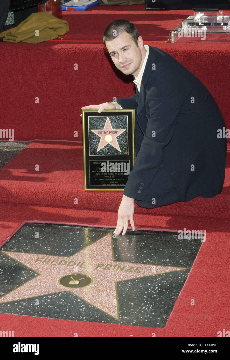 Actor Freddie Prinze, Jr. reaches out to touch the newly unveiled star