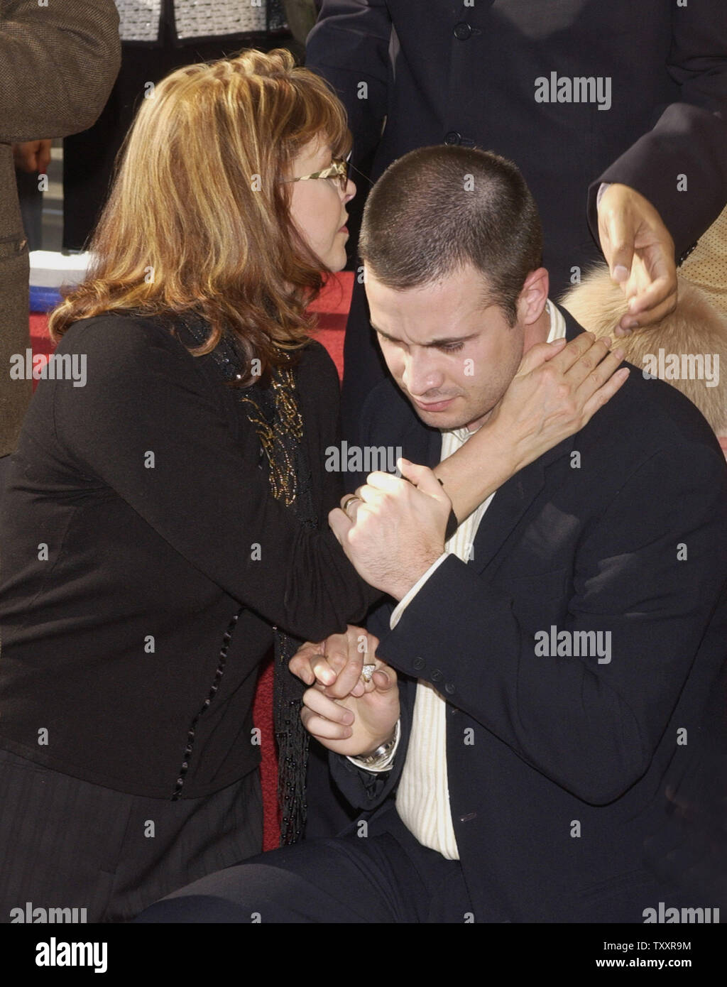 Actor Freddie Prinze, Jr. and his mother Kathy hug each other as his