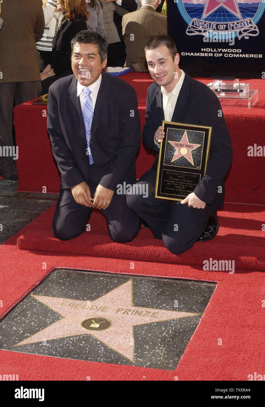 Actor Freddie Prinze, Jr. (R) holds a replica plaque as he poses with