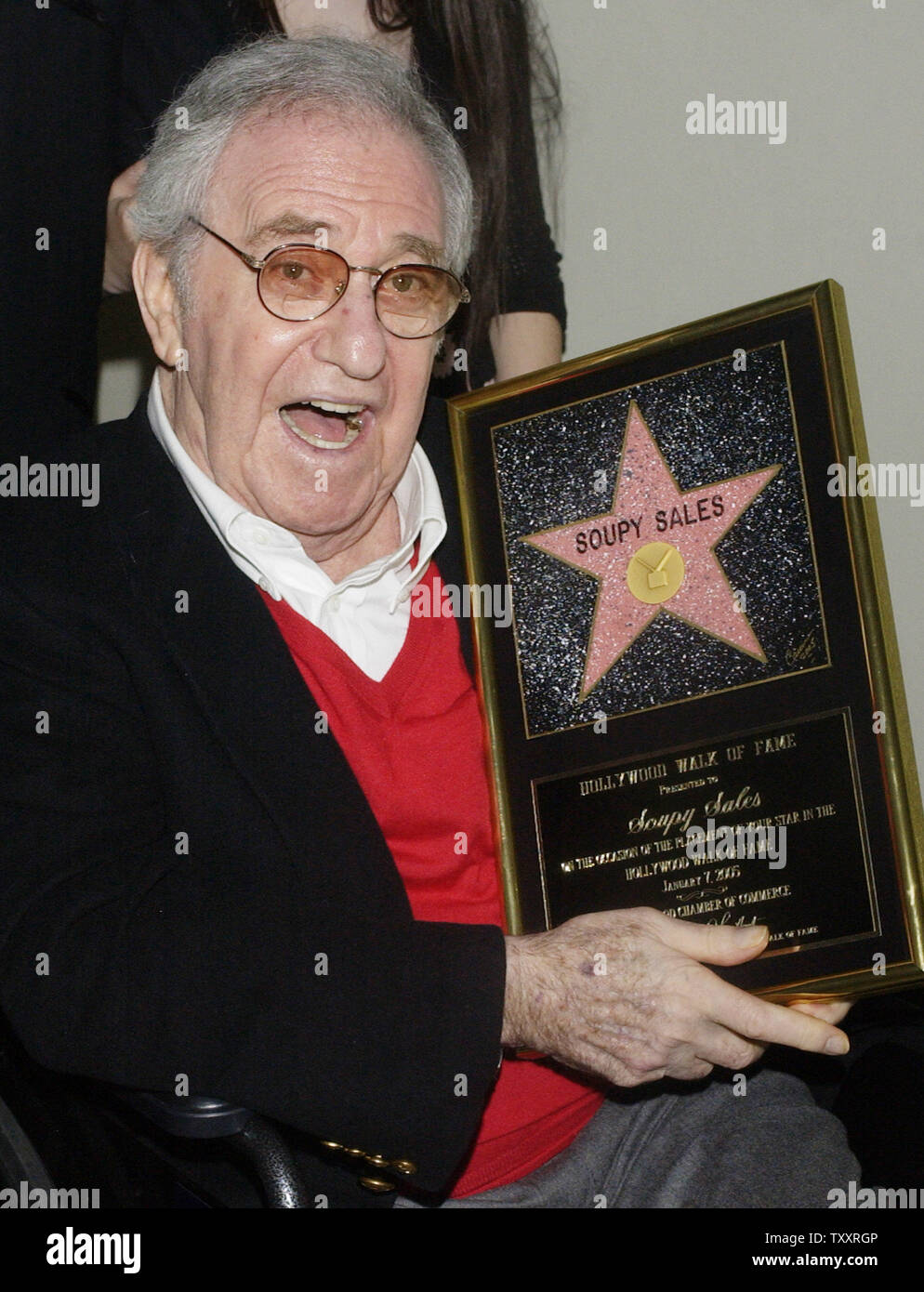 Comedian Soupy Sales holds a replica plaque of his just unveiled star on the Hollywood Walk of Fame following a brief, rain-soaked ceremony in Los Angeles on January 7, 2005. Sales, who will celebrate his 79th birthday on Saturday was famous for tossing cream-pies in the face's of celebrities during his 1950's variety show. (UPI Photo/Jim Ruymen) Stock Photo