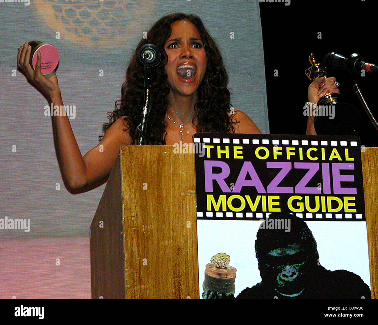 Halle Berry holds her Razzie award for Worst Actress of 2004 in one ...
