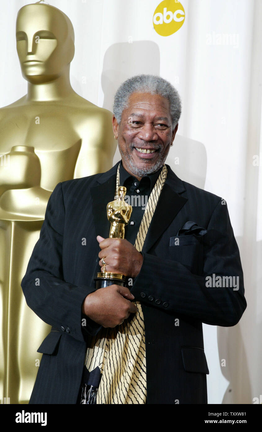 Morgan Freeman holds his statue after winning the best supporting actor