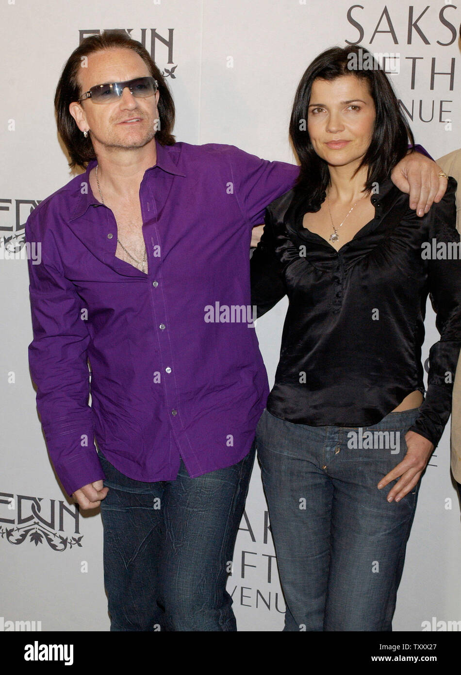 Bono (L), the lead singer for the rock band U2 and his wife Ali Hewson pose upon arriving for launch of new 'Conscious Commerce' clothing line EDUN in Beverly Hills, California March 25, 2005. EDUN is slated for a nationwide launch at 46 Saks Fifth Avenue stores across the U.S., making its debut in Beverly Hills.   (UPI Photo/Lazlo Fitz) Stock Photo
