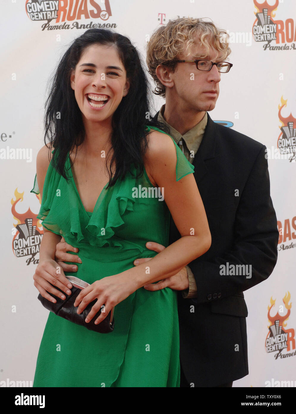 Actress Sarah Silverman (L) reacts as actor Andy Dick suddendly holds
