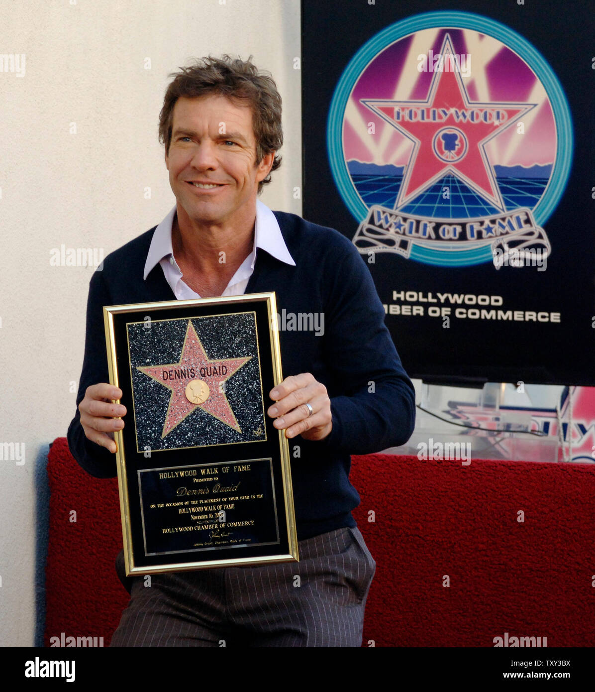 Actor Dennis Quaid, star of the upcoming holiday family comedy 'Yours, Mine and Ours' holds a replica plaque during an unveiling ceremony honoring Quaid with the 2,295th star on the Hollywood Walk of Fame in Los Angeles, California  November 16, 2005.  (UPI Photo/Jim Ruymen) Stock Photo