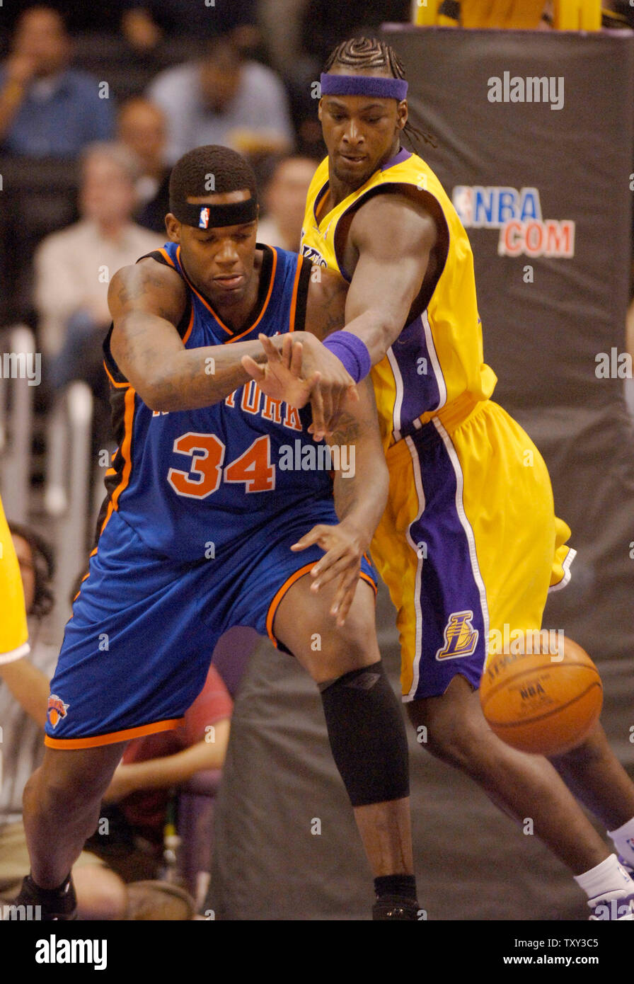 Los Angeles Lakers Forward Kwame Brown R Slaps The Ball Away From New York Knicks Center Eddy Curry For The Steal During First Quarter Nba Action In Los Angeles November 16 2005
