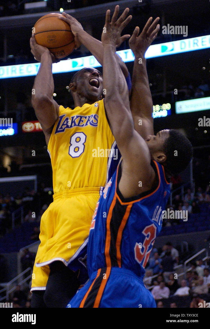 Los Angeles Lakers guard Kobe Bryant (L) scores over New York Knicks forward Antonio Davis during second quarter NBA action in Los Angeles November 16, 2005. (UPI Photo/Jim Ruymen) Stock Photo