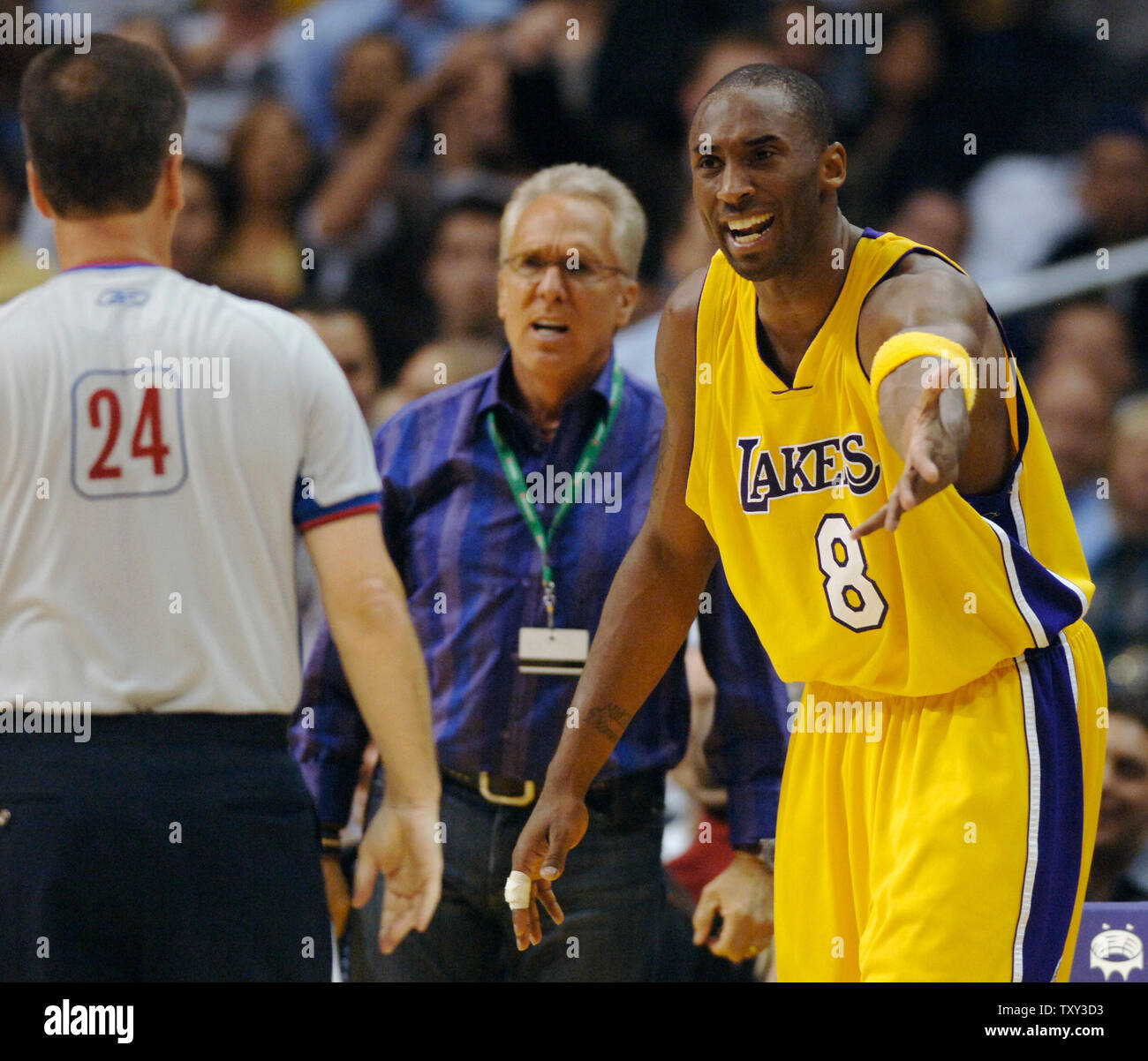 Los Angeles Lakers guard Kobe Bryant argues a call  in the waning minute of fourth quarter action of the Lakers/Clippers NBA game in Los Angeles, California on November 18, 2005. The Clippers defeated the Lakers 97-91. Looking on is Westwood One founder Norm Pattiz (C).   (UPI Photo/Jim Ruymen) Stock Photo