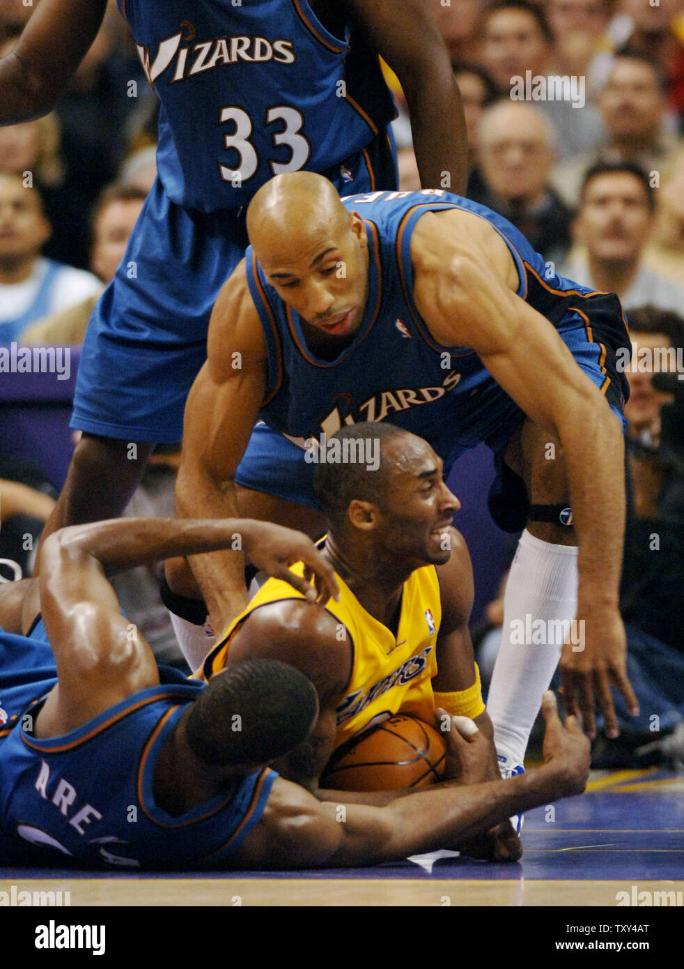 Los Angeles Lakers guard Kobe Bryant (C) fights for control of the ball as he is surrounded by Washingtron Wizzards Gilbert Arenas, Brendan Haywood and Michael Ruffin during fourth quarter NBA action at Staples Center in Los Angeles December 16, 2005. The Lakers defeated the Wizzards 97-91. (UPI Photo/Jim Ruymen) Stock Photo
