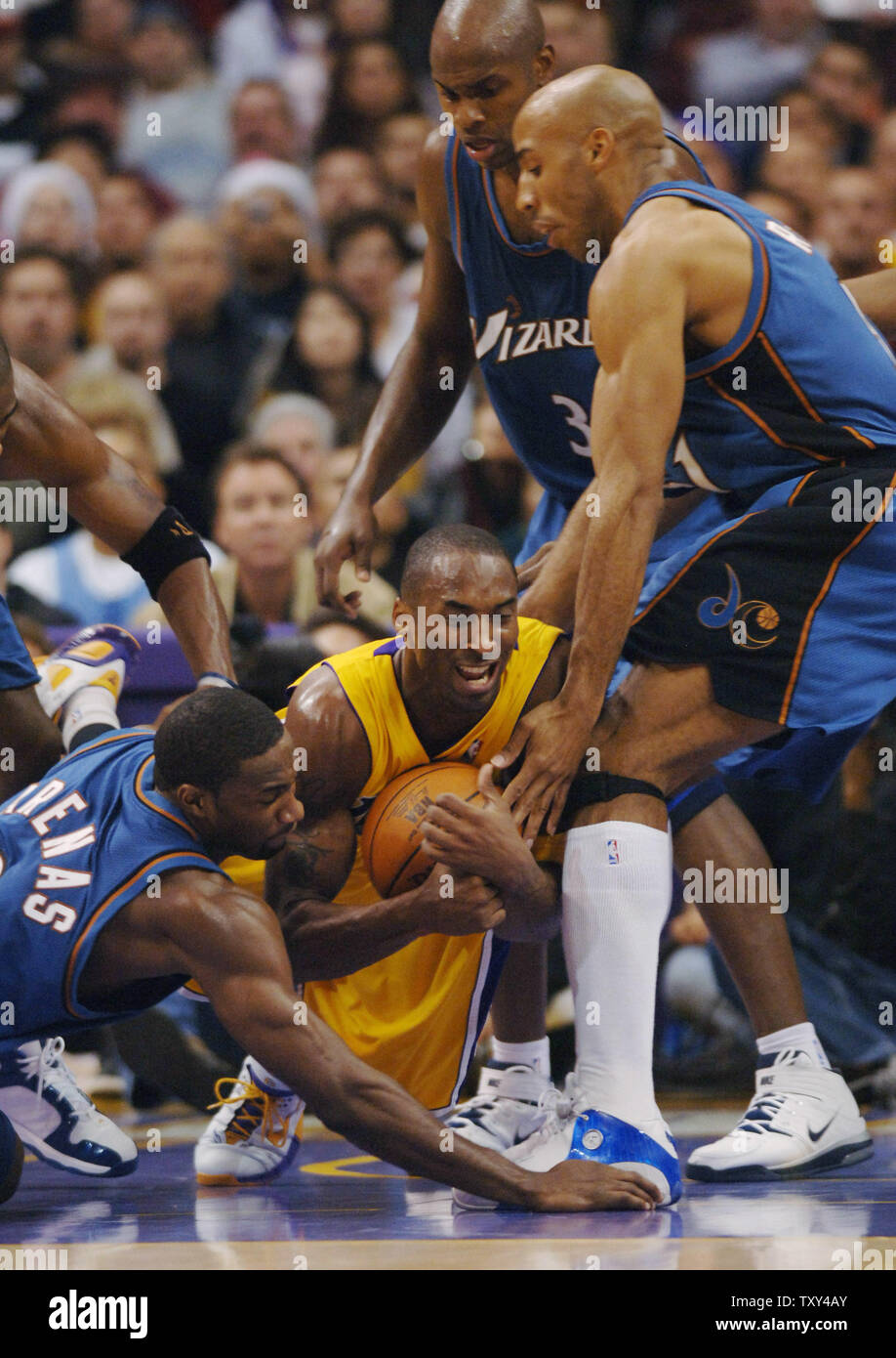 Los Angeles Lakers guard Kobe Bryant (C) fights for control of the ball as he is surrounded by Washingtron Wizzards Gilbert Arenas, Brendan Haywood and Michael Ruffin during fourth quarter NBA action at Staples Center in Los Angeles December 16, 2005. The Lakers defeated the Wizzards 97-91. (UPI Photo/Jim Ruymen) Stock Photo