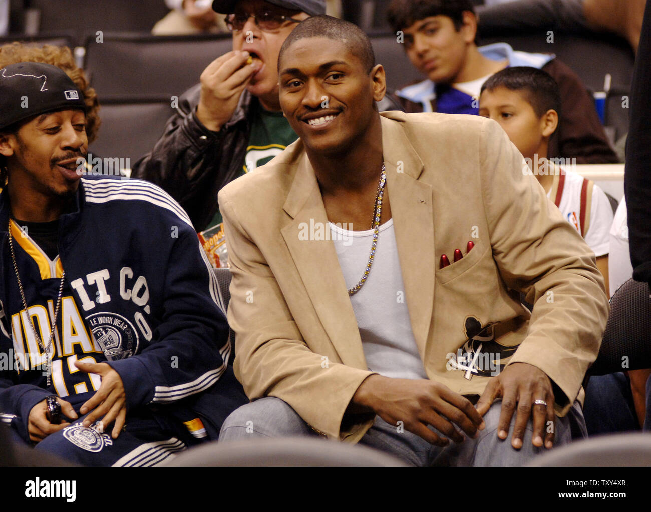 Indiana Pacers Ron Artest (R) watches the NBA game between the Cleveland Cavaliers and the Los Angeles Lakers in Los Angeles January 12, 2006. Artest asked to be traded last month, and although he withdrew the statement, team president Larry Bird said he is no longer interested in having Artest play for the team. Artest hasn't played in a game since December 6, 2005. (UPI Photo/Jim Ruymen) Stock Photo