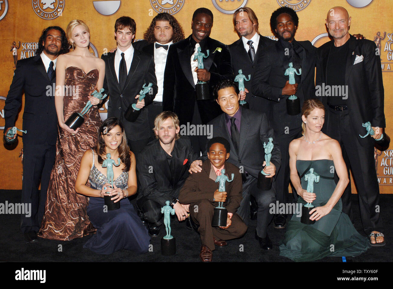 The cast of the series "Lost" celebrate with their trophies backstage for  their win in the category of outstanding performance by an ensemble in a  drama series at the 12th annual Screen