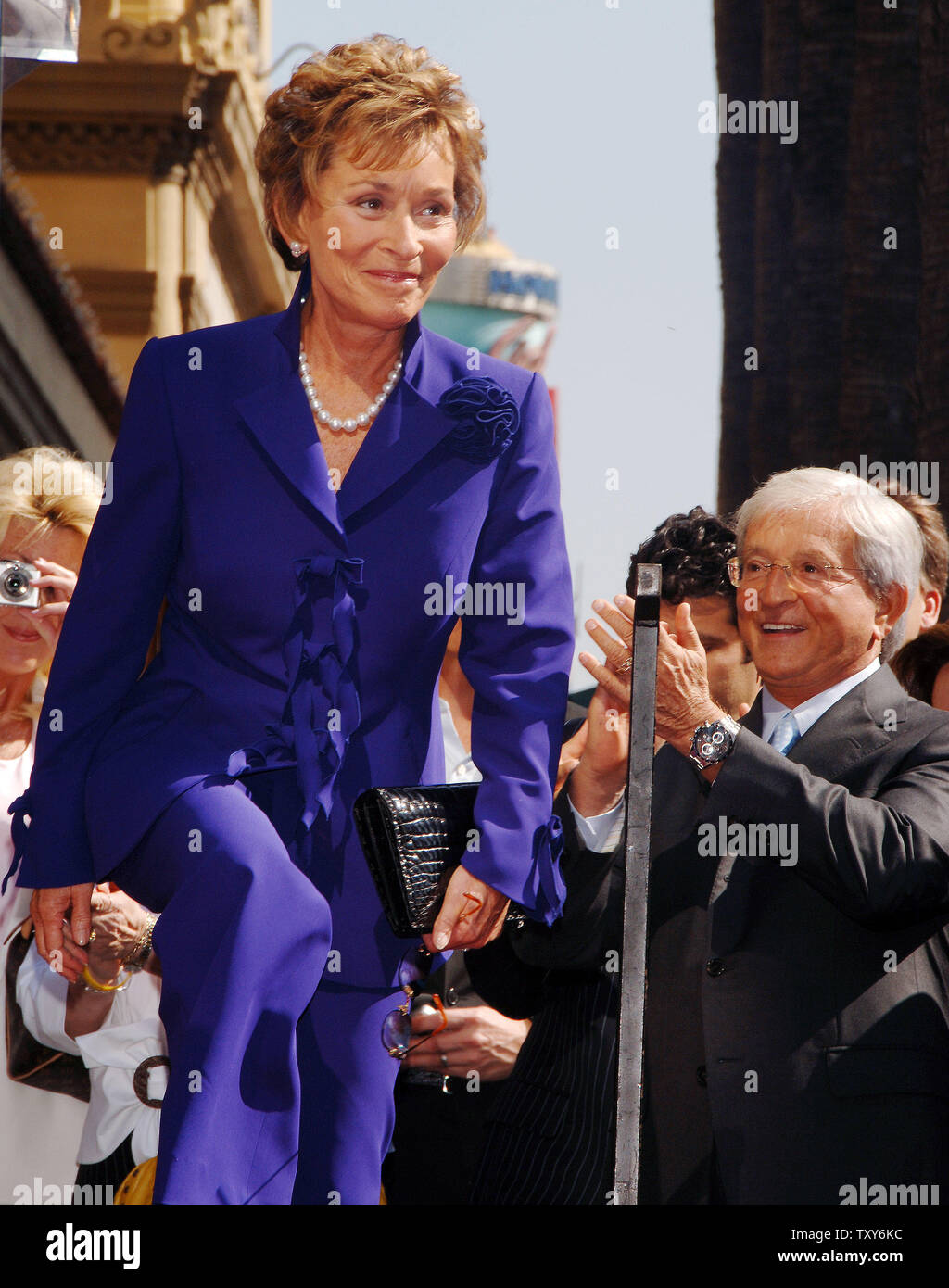 Judge Judy Sheindlin, the star of television's number one syndicated courtroom series that bears her name, is introduced during a ceremony honoring her with the 2,304th star on the Hollywood Walk of Fame in Los Angeles, California February 14, 2006. Applauding at right is her husband Judge Jerry Sheindlin.  (UPI Photo/Jim Ruymen) Stock Photo