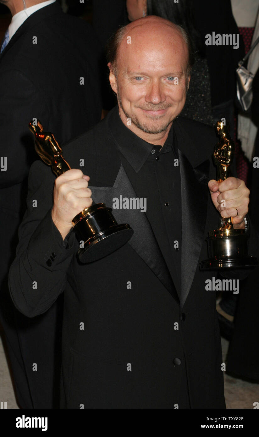 Best picture ("Crash") director Paul Haggis arrives with his Oscars on