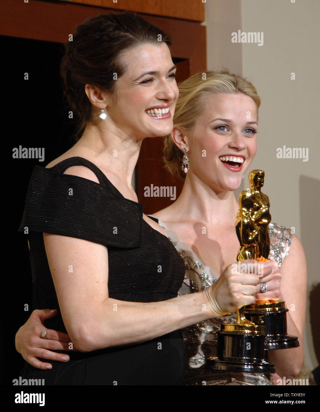 Reese Witherspoon (R) appears backstage with the Oscar she won for best ...