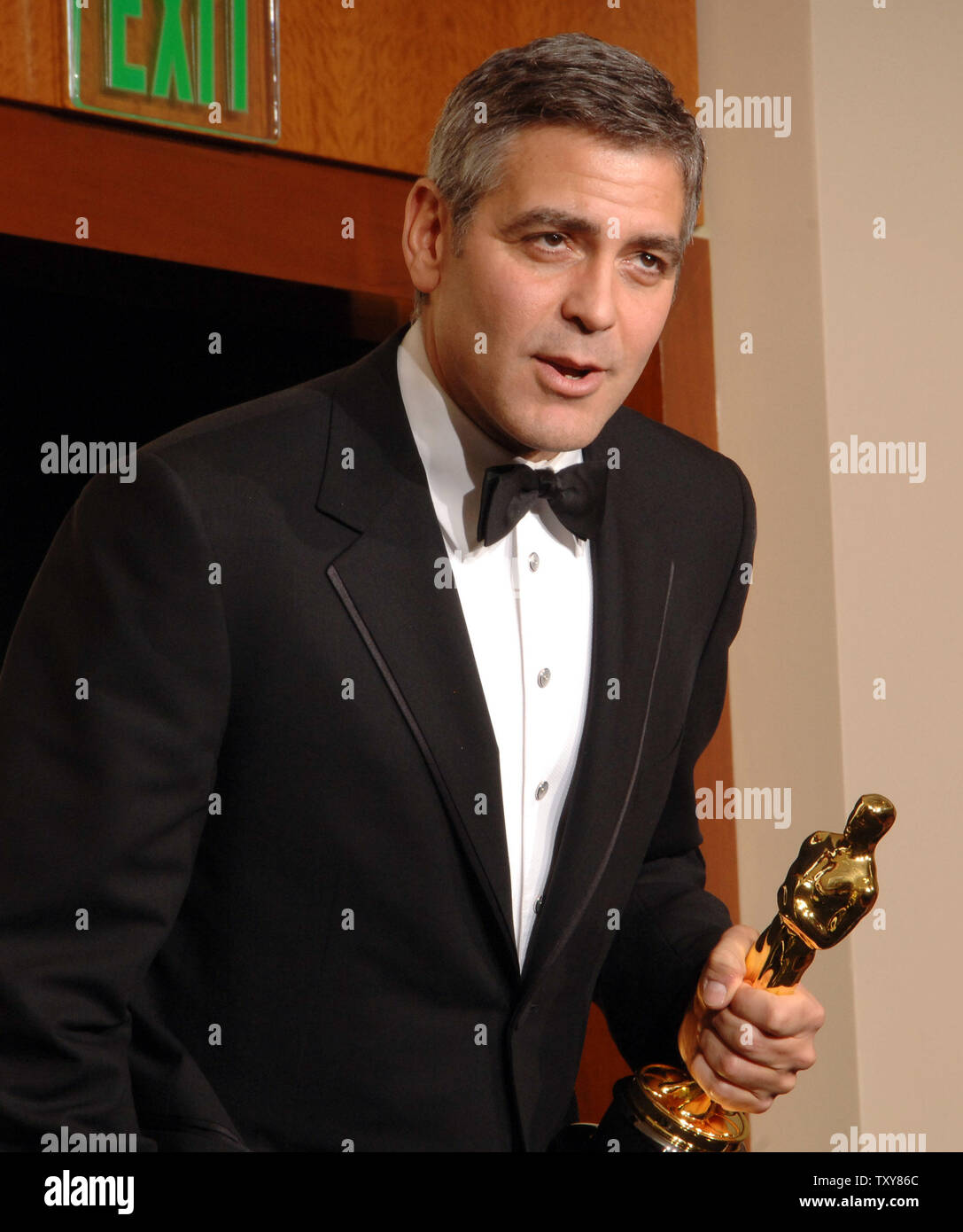 Clooney appears backstage with the best supporting actor Oscar