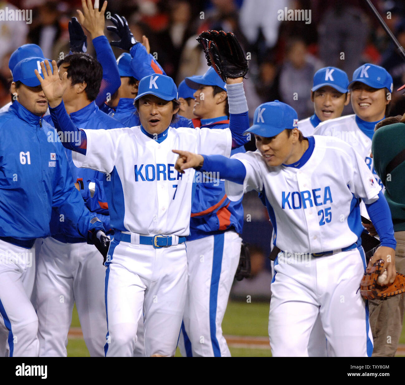 South Korea's Jong Beom Lee (#7) and Seung Youp Lee(#25) celebrate after  their