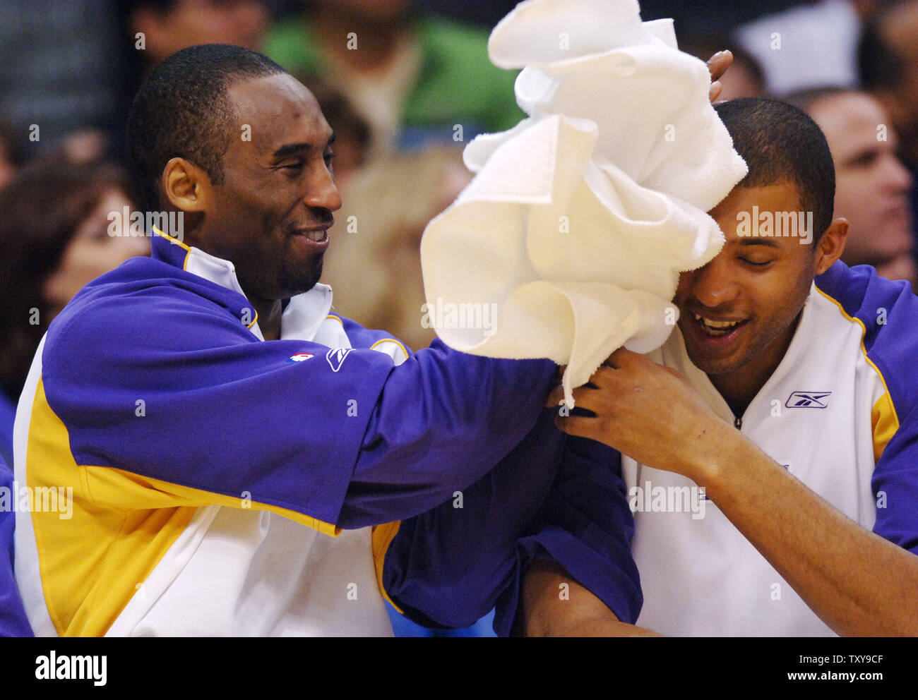 Los Angeles Lakers' guard Kobe Bryant (L) gets playful with teammate Brian  Cook on the bench in the waning moments of their NBA basketball game  against the Houston Rockets at Staples Center