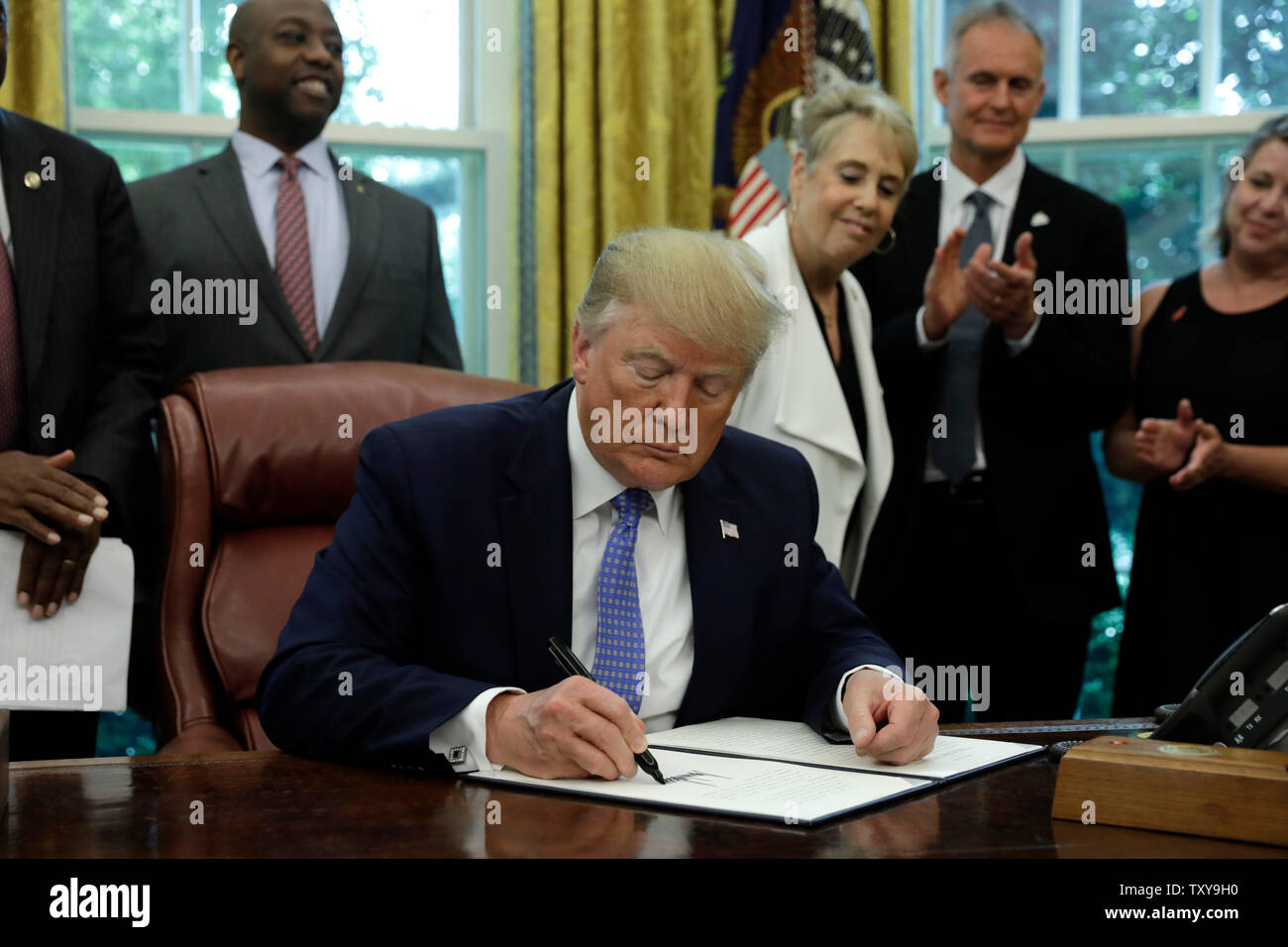 Washington, DC. 25th June, 2019. US President Donald Trump signs an Executive Order Establishing a White House Council on Eliminating Regulatory Barriers to Affordable Housing in the Oval Office at the White House in Washington, DC, on June 25, 2019. Credit: Yuri Gripas/Pool via CNP | usage worldwide Credit: dpa/Alamy Live News Stock Photo