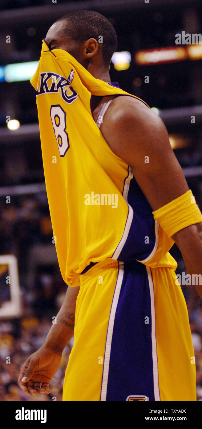 Los Angeles Lakers' Kobe Bryant covers his face with his jersey ...