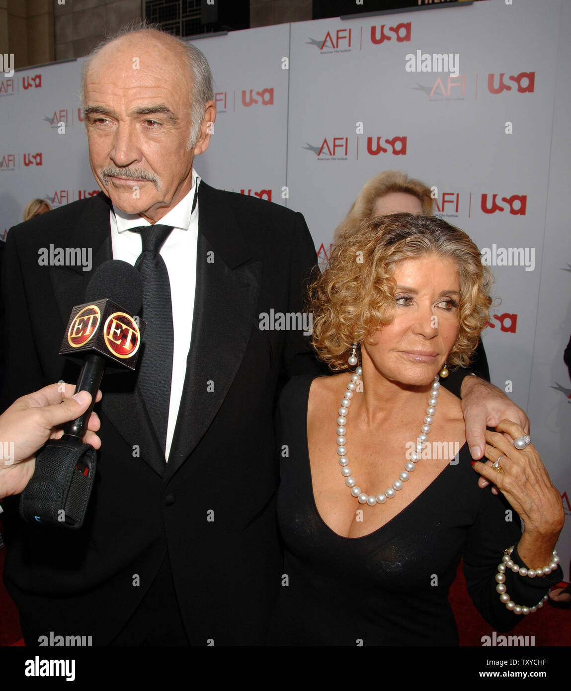 Sean Connery (L) and wife Micheline arrive for American Film Institute's 'AFI Life Achievement Award: A Tribute to Sir Sean Connery' taping in the Hollywood section of Los Angeles, California on June 8, 2006. Actor Harrison Ford presented the Lifetime Achievement Award to Connery. The two actors starred together in the 1989 film 'Indiana Jones and the Last Crusade.'  (UPI Photo/Jim Ruymen) Stock Photo