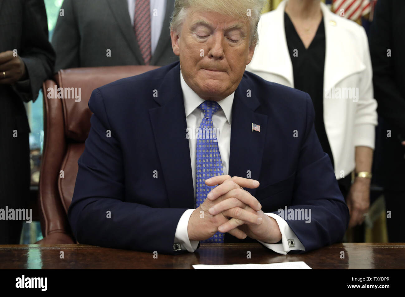 Washington, District of Columbia, USA. 25th June, 2019. US President Donald Trump pauses as he talks to the media after signing an Executive Order Establishing a White House Council on Eliminating Regulatory Barriers to Affordable Housing in the Oval Office at the White House in Washington, DC, on June 25, 2019 Credit: Yuri Gripas/CNP/ZUMA Wire/Alamy Live News Stock Photo