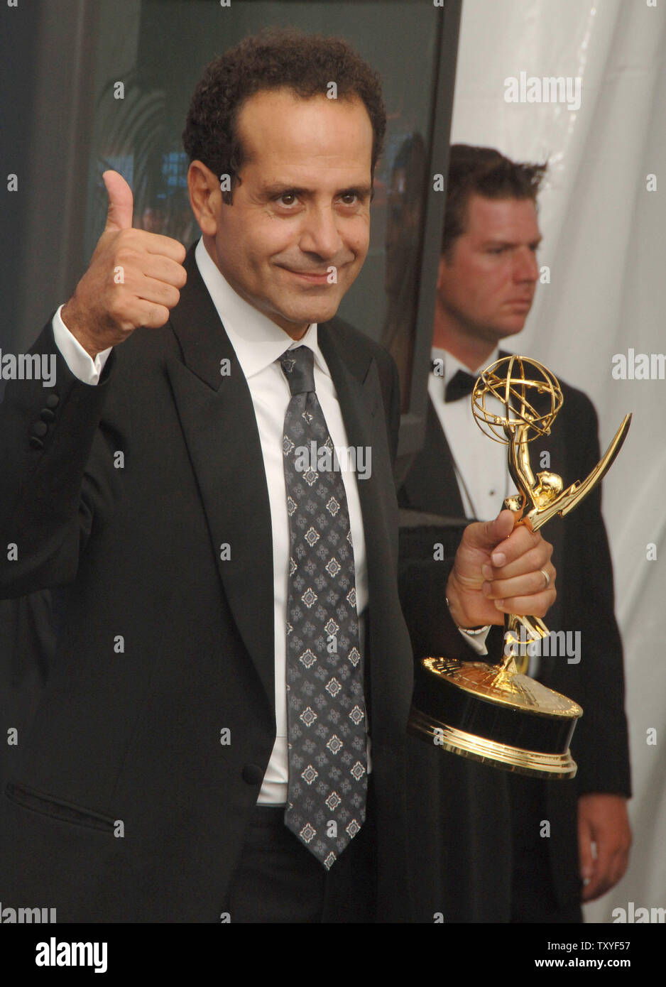 Tony Shalhoub gives a thumbs up as he holds his Emmy award for leading actor in a comedy series for 'Monk'  at the 58th annual Primetime Emmy awards at the Shrine Auditorium in Los Angeles, California on August 27, 2006. (UPI Photo/Jim Ruymen) Stock Photo