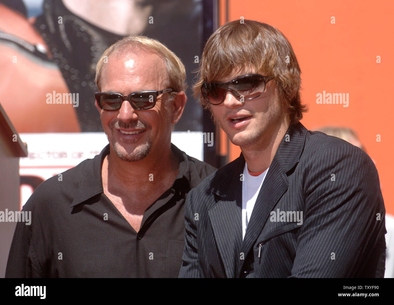Actor Kevin Costner (L) and actor Ashton Kutcher attend a ceremony