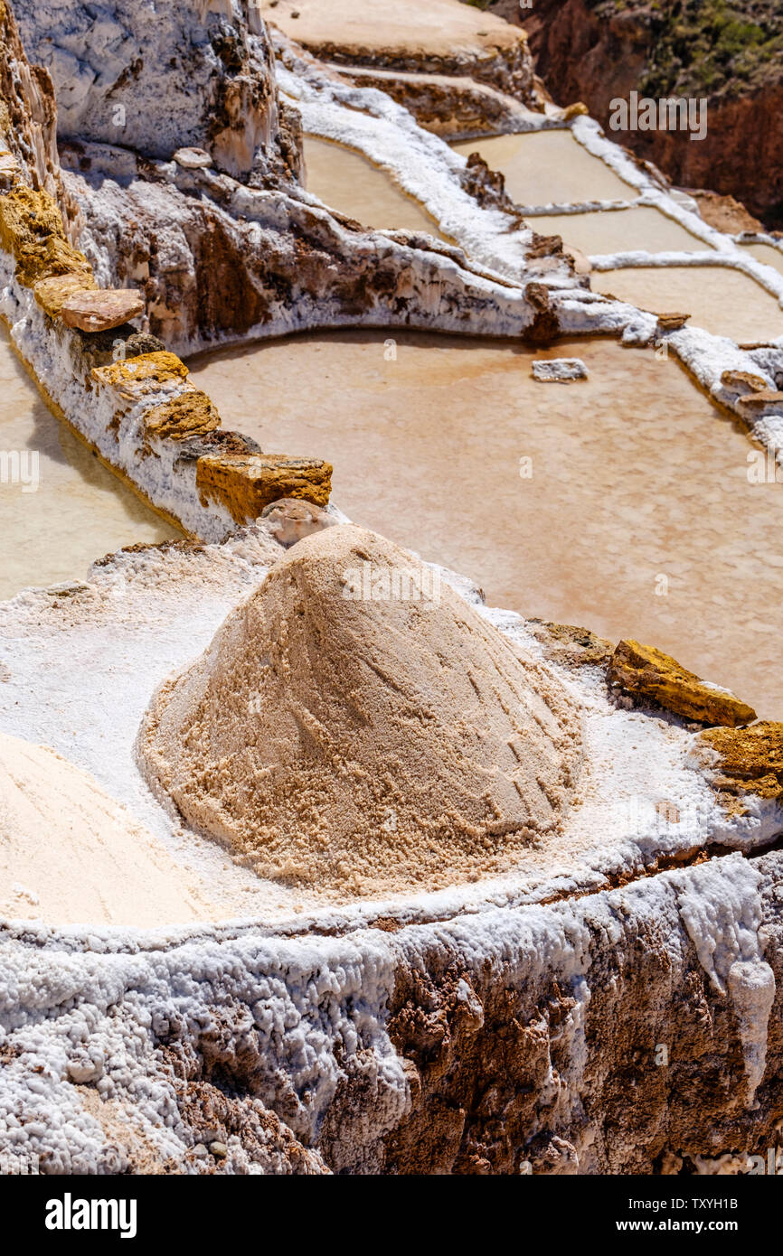 Salt pile at Salineras de Maras / Maras Salt Mines. Salt extraction at Maras salt pans, terraces and ponds, Peru Sacred Valley. Stock Photo