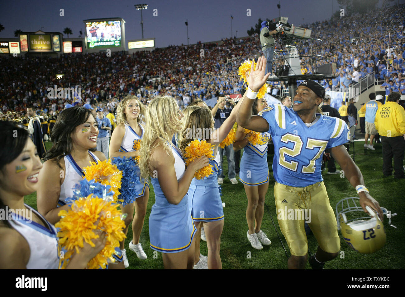 UCLA safety Aaron Ware high fives cheerleaders after defeating USC at the Rose Bowl 13-9 in Pasadena, California on December 2, 2006. UCLA's win keeps USC out of the Bowl Championship Series Game. (UPI Photo/Jon SooHoo) Stock Photo