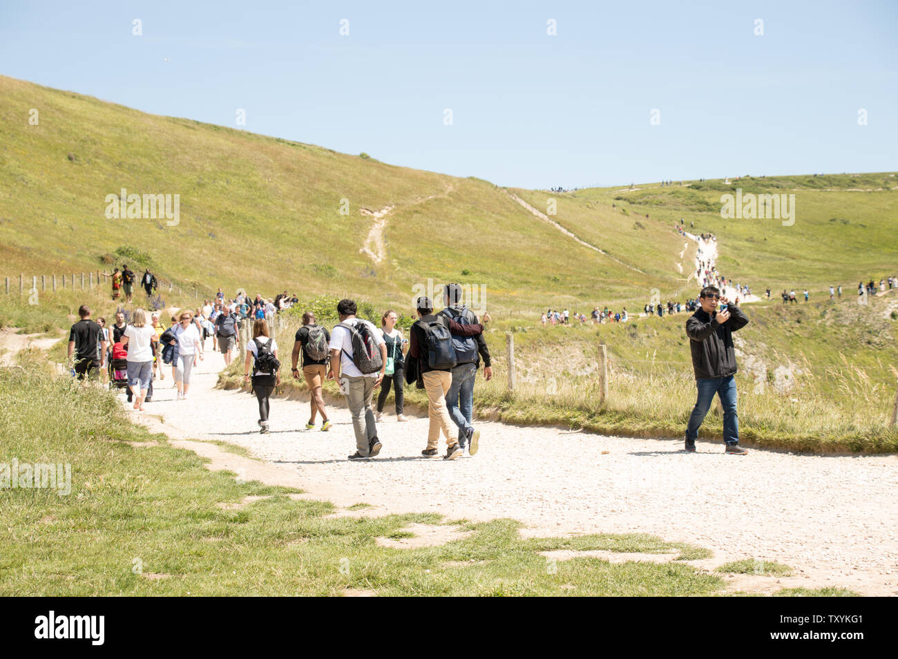 Durdle Door, England, UK - June 2019: People ascend up the Jurassic Coast after enjoying the beach at Durdle Door on hot summer day in June 2019 Stock Photo