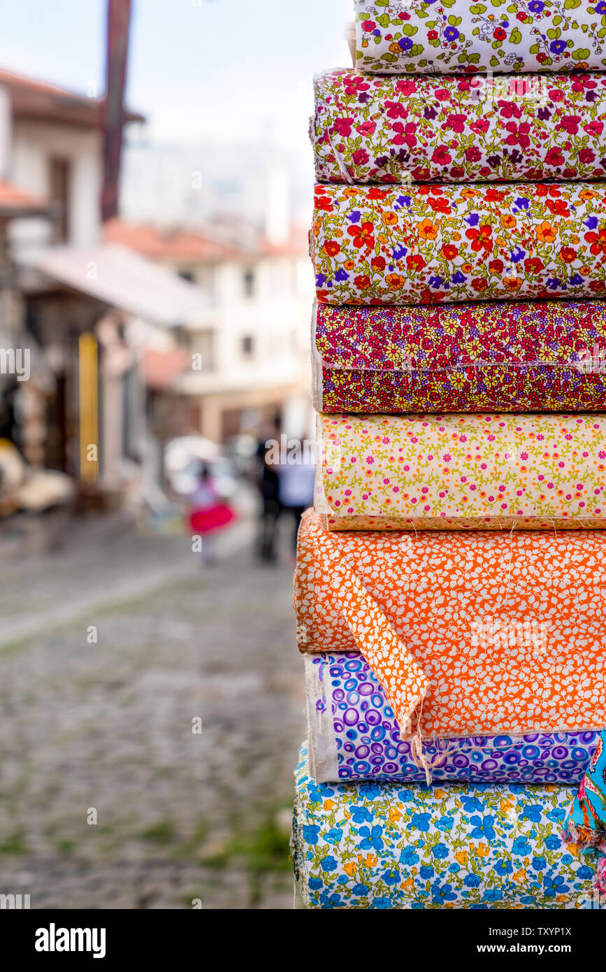 Traditional Turkish fabrics in the bazaar and street can be seen just near the fabrics. Stock Photo
