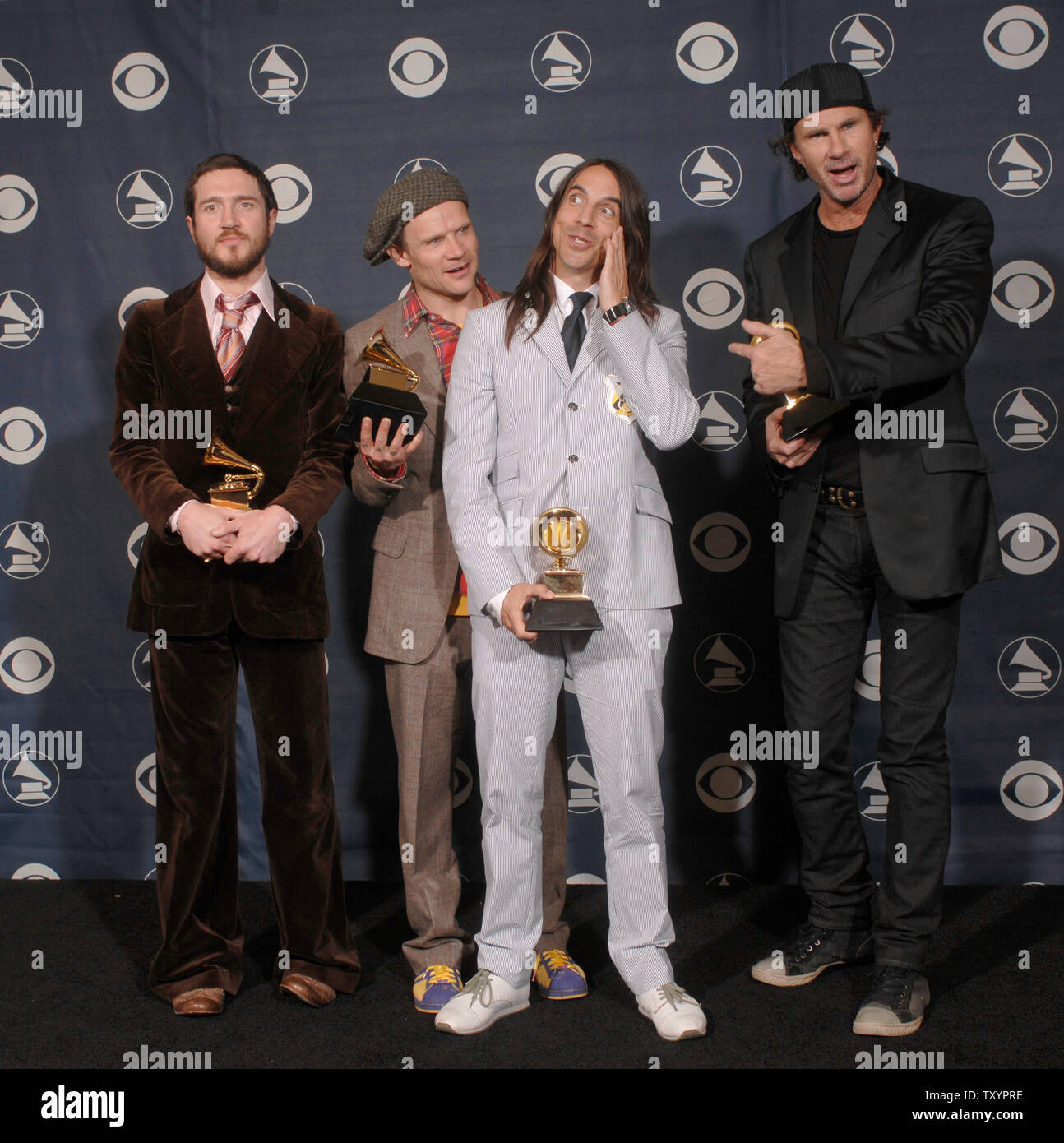 The Red Hot Chili Peppers (L-R), John Frusciantea, Flea, Anthony Kiedis and  Chad Smith show their Grammys for best rock song, best rock album and best  rock performance at the 49th annual