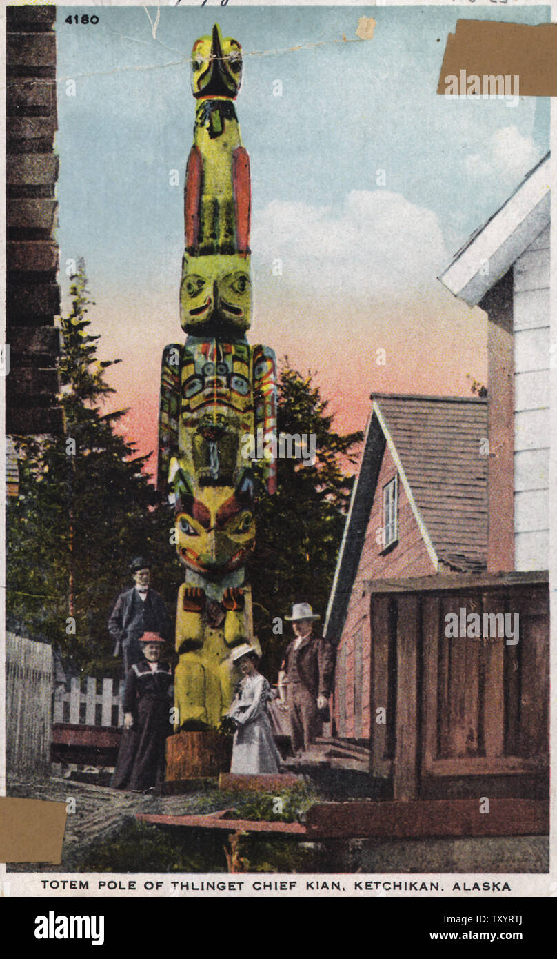 Color post card. Totem pole of Thlinget Chief Kian. One of the most noted of the totem poles of Ketchikan is the famous totem of Chief Kian. It is surmounted by the fabled bird Ka-juk. Below this bird is the eagle and below the eagle is the wolf. Stock Photo