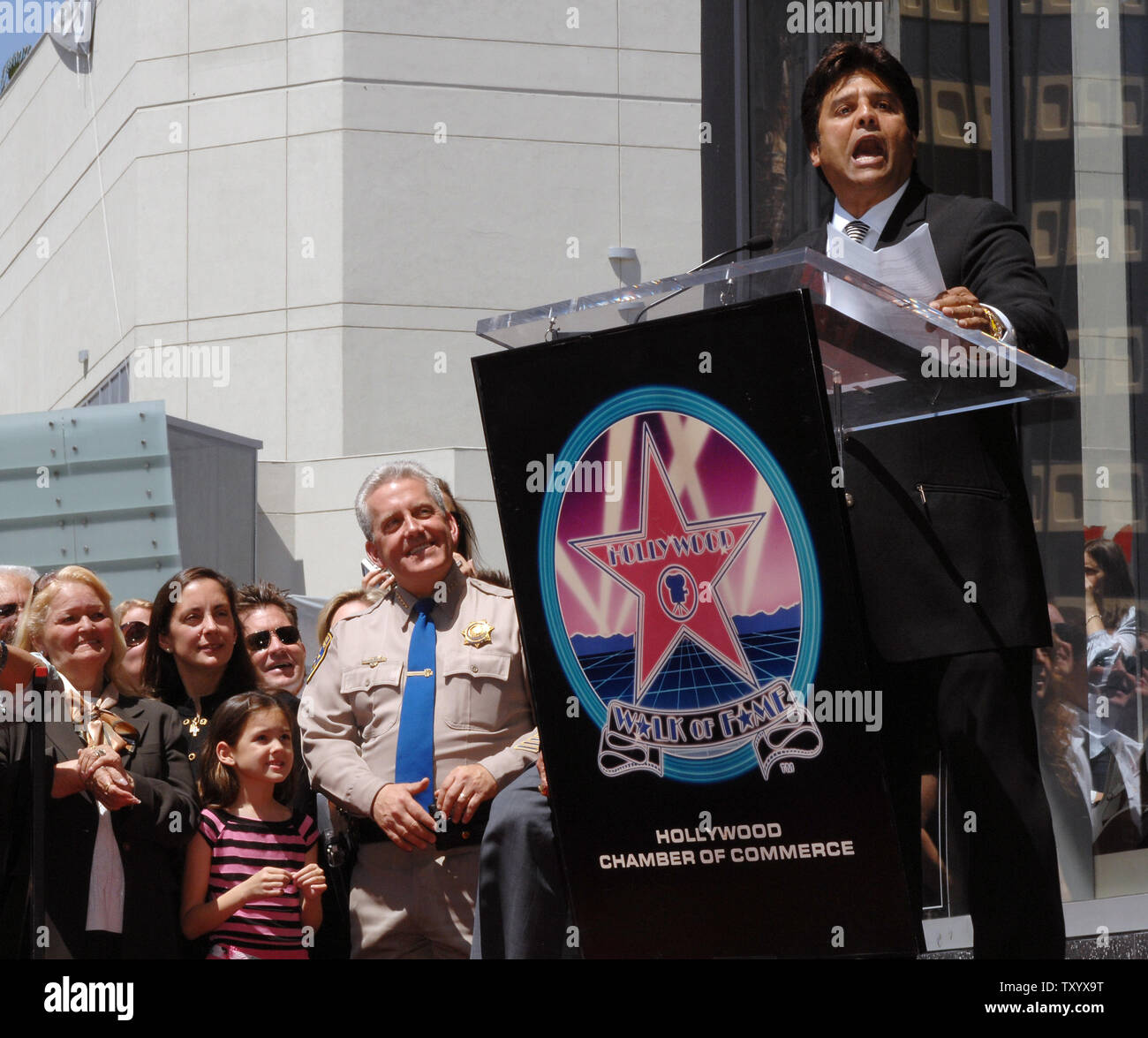 Actor Erik Estrada (R), best known for his role as Officer Frank 'Ponch' Poncherello in the 1977-1983 television series 'CHiPS' speaks during ceremonies unveiling Estrada's star on the Hollywood Walk of Fame in Los Angeles on April 19, 2007. Looking on in rear are his mother Carmen, wife Nanette, daughter Francesca and CHP Commisioner Mike Brown (L-R). (UPI Photo/Jim Ruymen) Stock Photo