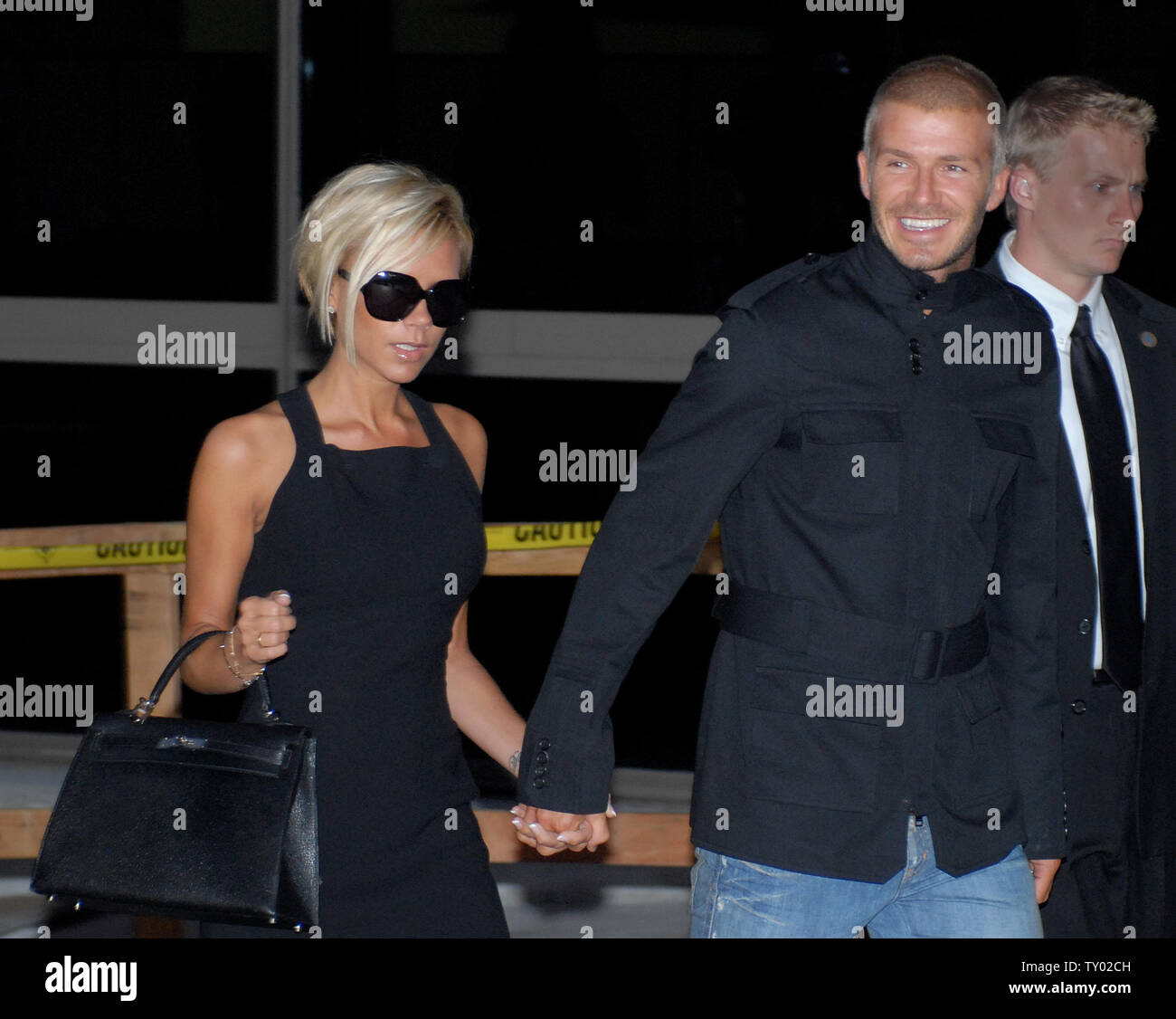 Soccer great David Beckham and his wife Victoria (Posh Spice of the Spice Girls) arrive at LAX in Los Angeles on July 12, 2007.  Beckham will play for the Major League Soccer team, Los Angeles Galaxy, with a five year, $32.5 million contract.  (UPI Photo/John Hayes) Stock Photo