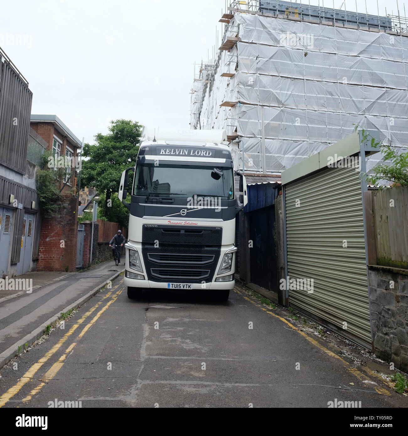 June 2019 - Large truck in a narrow city road for unloading on to a construction site Stock Photo