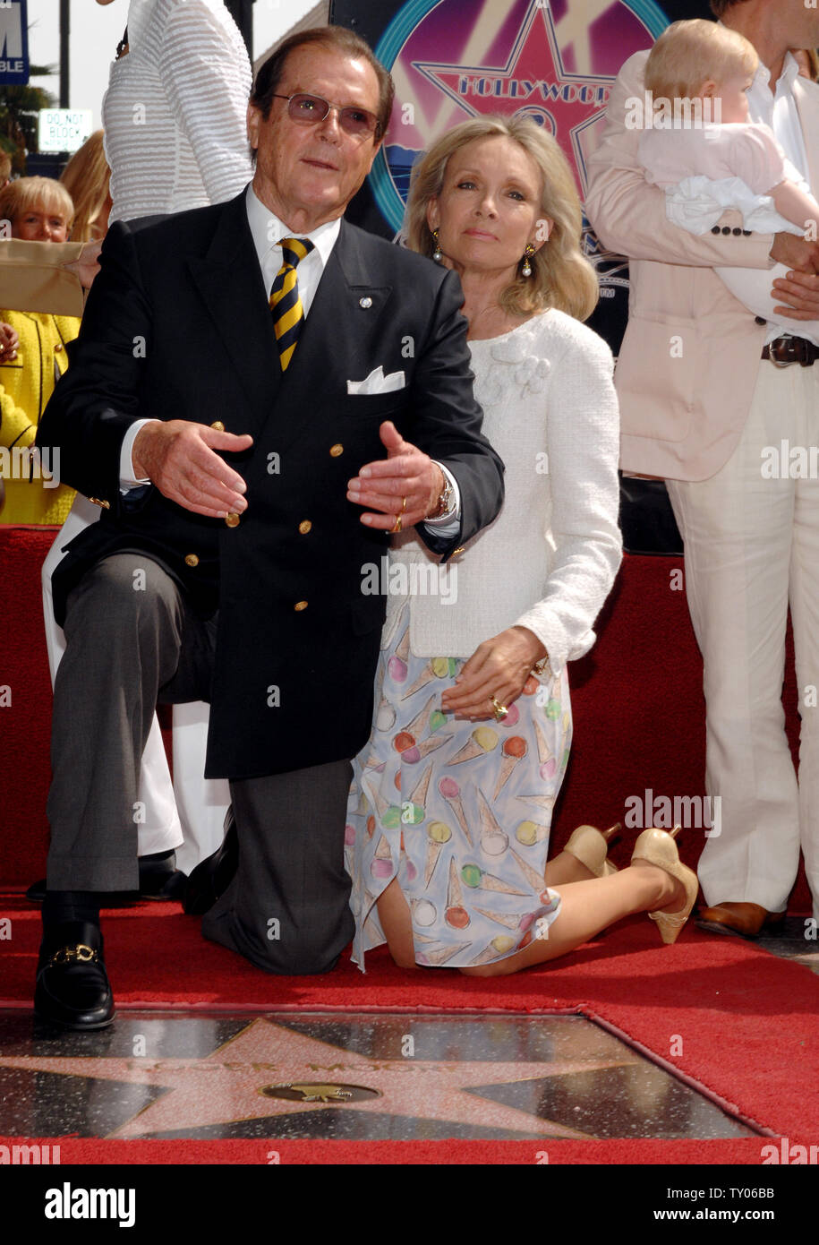 British actor Sir Roger Moore (L) and his wife, actress Christina Tholstrup pose during an unveiling ceremony honoring him with the 2,350th star on the Hollywood Walk of Fame in Los Angeles on October 11, 2007. Moore appeared in 1973 in his first James Bond film 'Live and Let Die.' He also starred as Simon Templar in the TV series 'The Saint.'  (UPI Photo/Jim Ruymen) Stock Photo