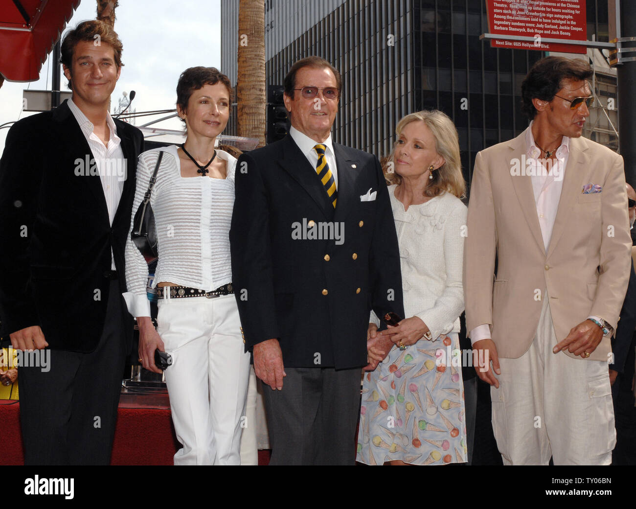 British actor Sir Roger Moore (C) poses with his wife, actress Christina Tholstrup (4th-L) and children Geoffrey (L), Deborah (2nd-L) and Christian (R), following an unveiling ceremony honoring him with the 2,350th star on the Hollywood Walk of Fame in Los Angeles on October 11, 2007. Moore appeared in 1973 in his first James Bond film 'Live and Let Die.' He also starred as Simon Templar in the TV series 'The Saint.'  (UPI Photo/Jim Ruymen) Stock Photo