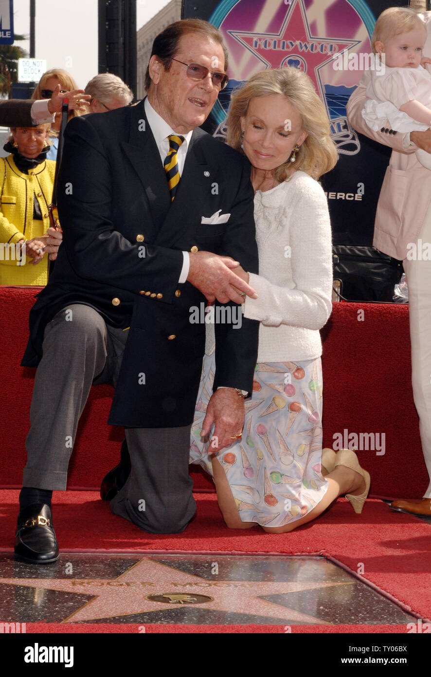 British actor Sir Roger Moore (L) and his wife, actress Christina Tholstrup pose during an unveiling ceremony honoring him with the 2,350th star on the Hollywood Walk of Fame in Los Angeles on October 11, 2007. Moore appeared in 1973 in his first James Bond film 'Live and Let Die.' He also starred as Simon Templar in the TV series 'The Saint.'  (UPI Photo/Jim Ruymen) Stock Photo