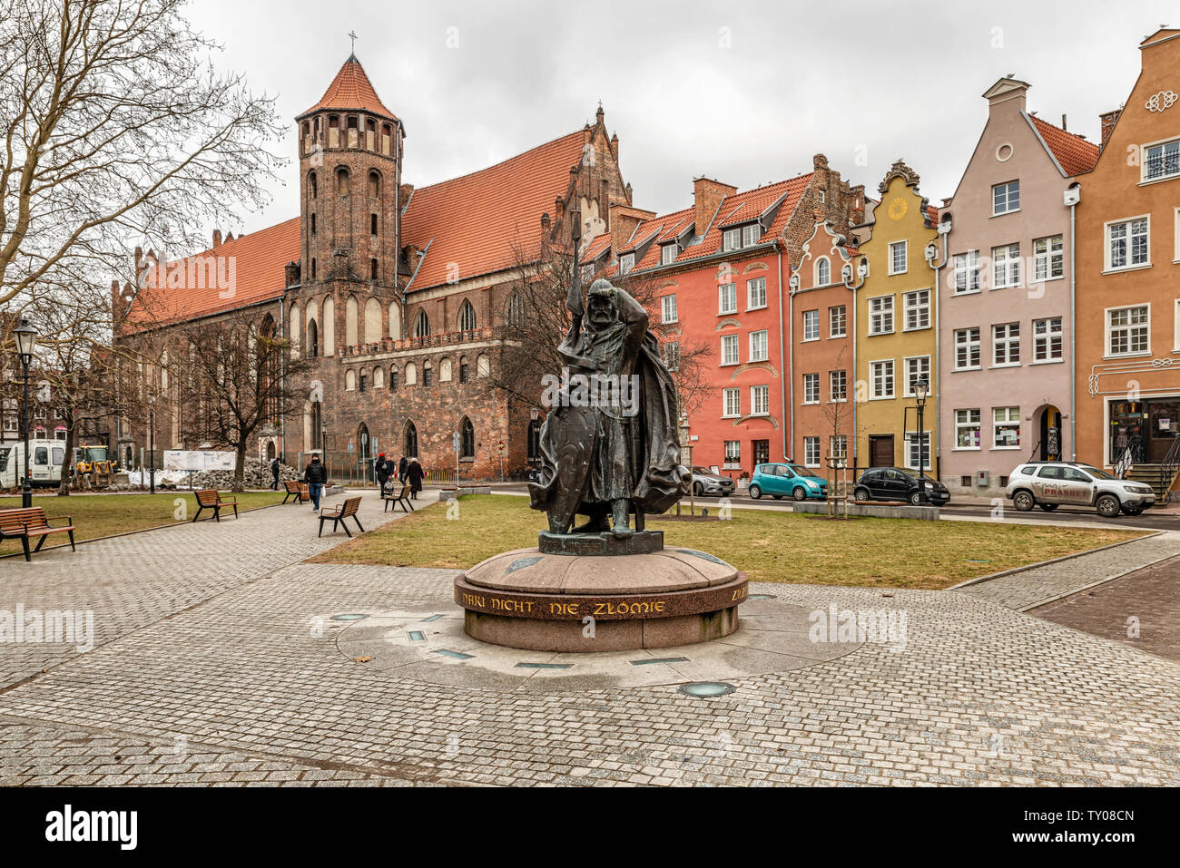 Gdansk, Poland - Feb 14, 2019: View at the medieval knight, warrior monument and St Nicholas catholic church in Gdansk, Poland. Stock Photo