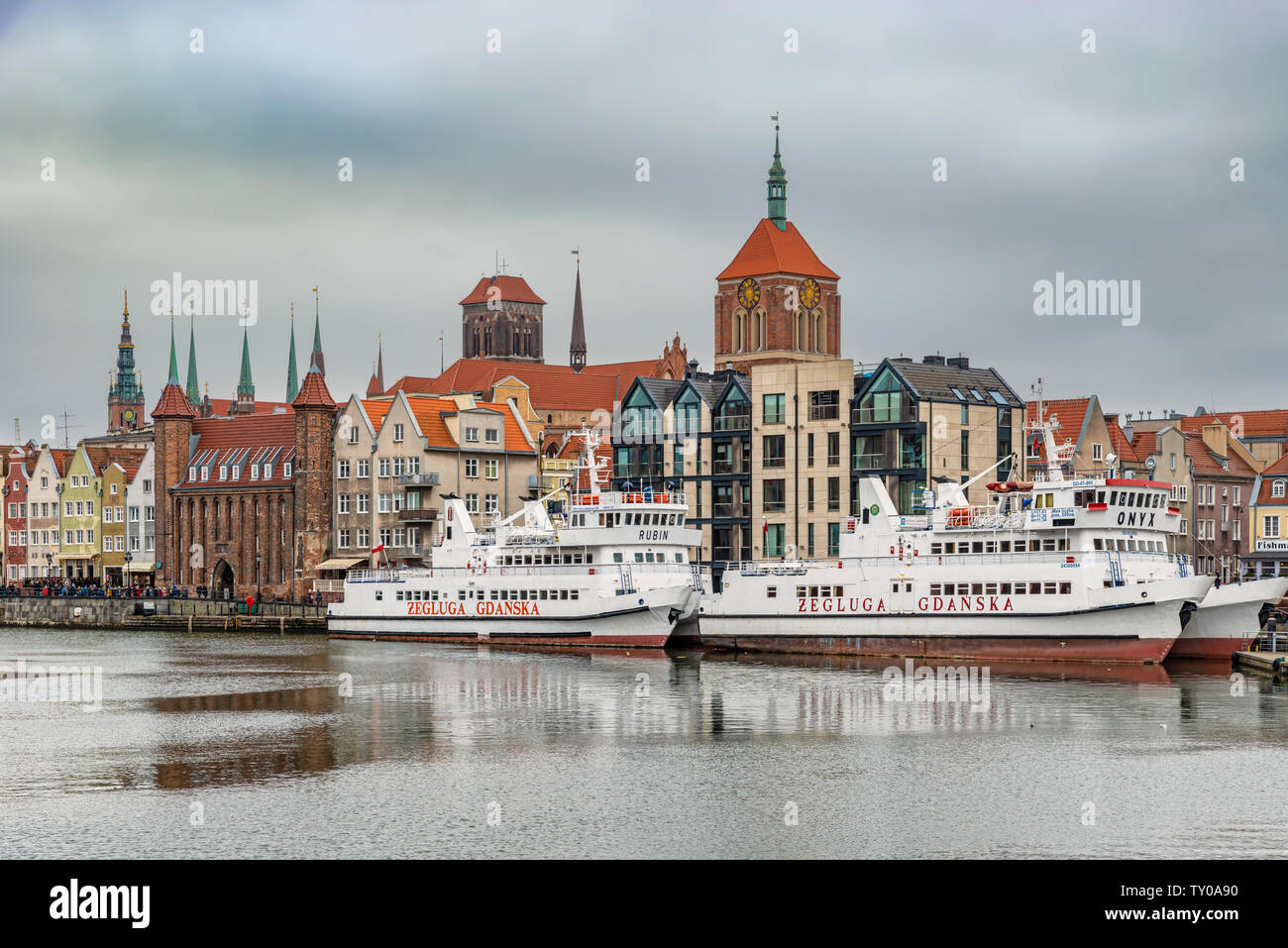 Gdansk, Poland – Feb 14, 2019: View at historic houses along Motlawa river and touris boats in the old historic town of the Gdansk city in Poland. Stock Photo
