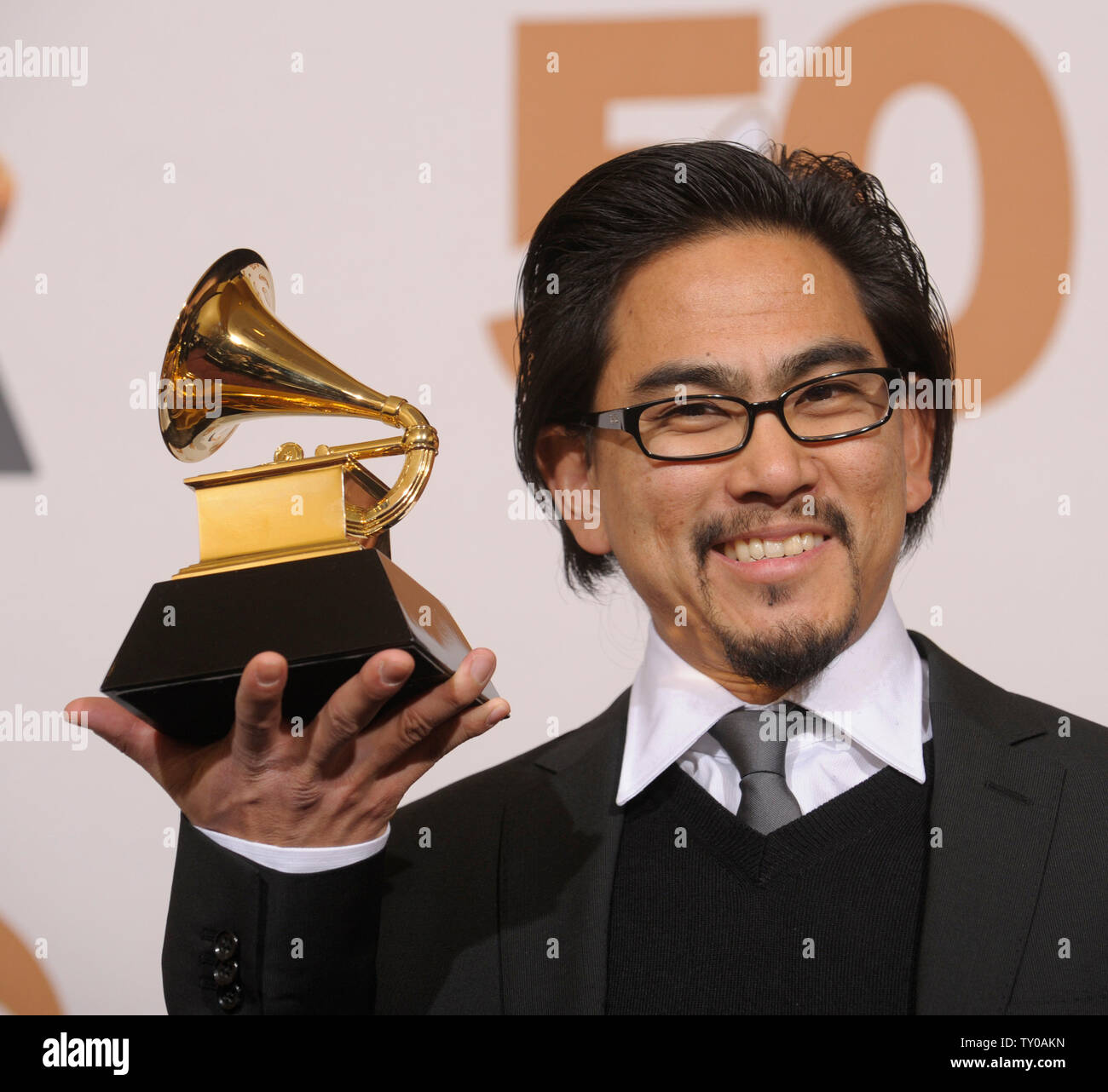 Masaki Koike holds his Grammy for Best Boxed or Special Limited 